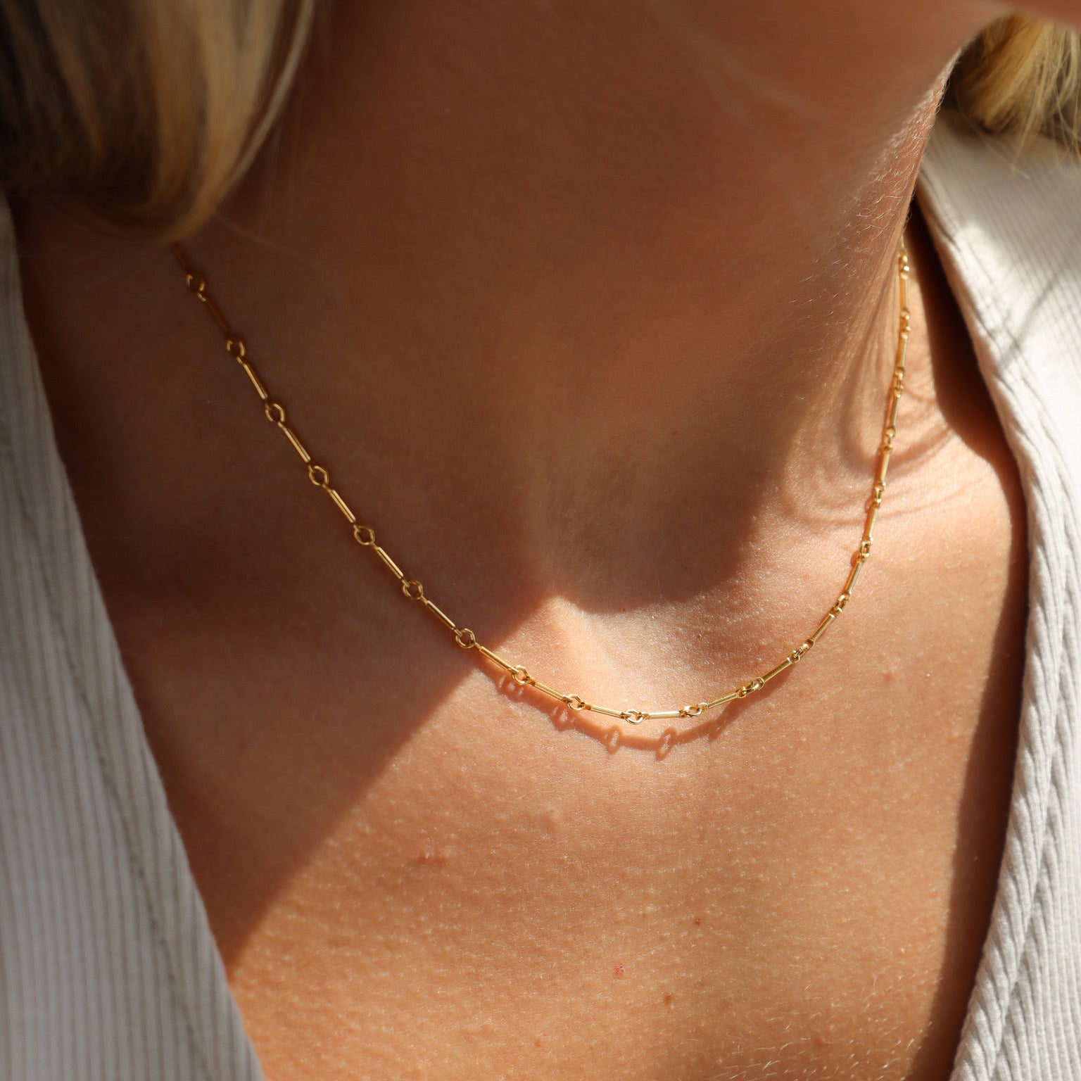 model wearing 14k gold fill bar and link chain necklace 