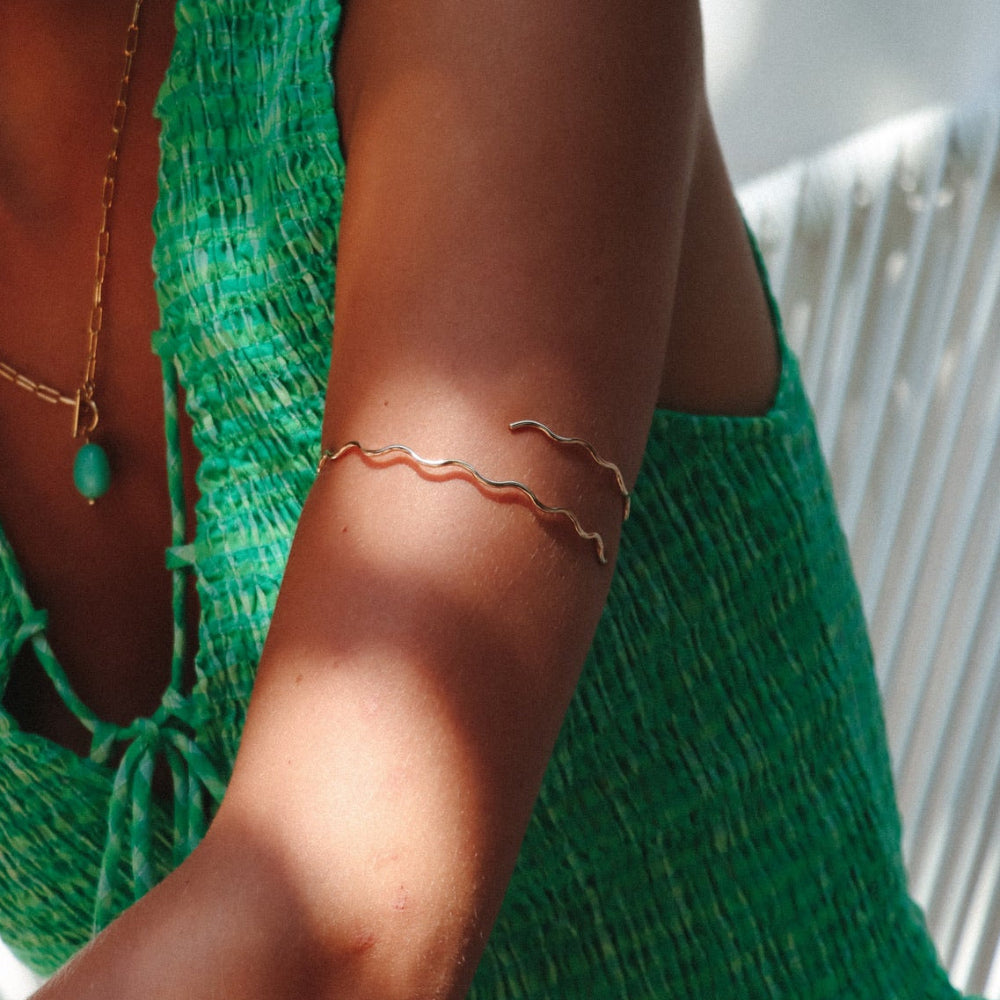 model wearing 14k gold fill wavy arm cuff 