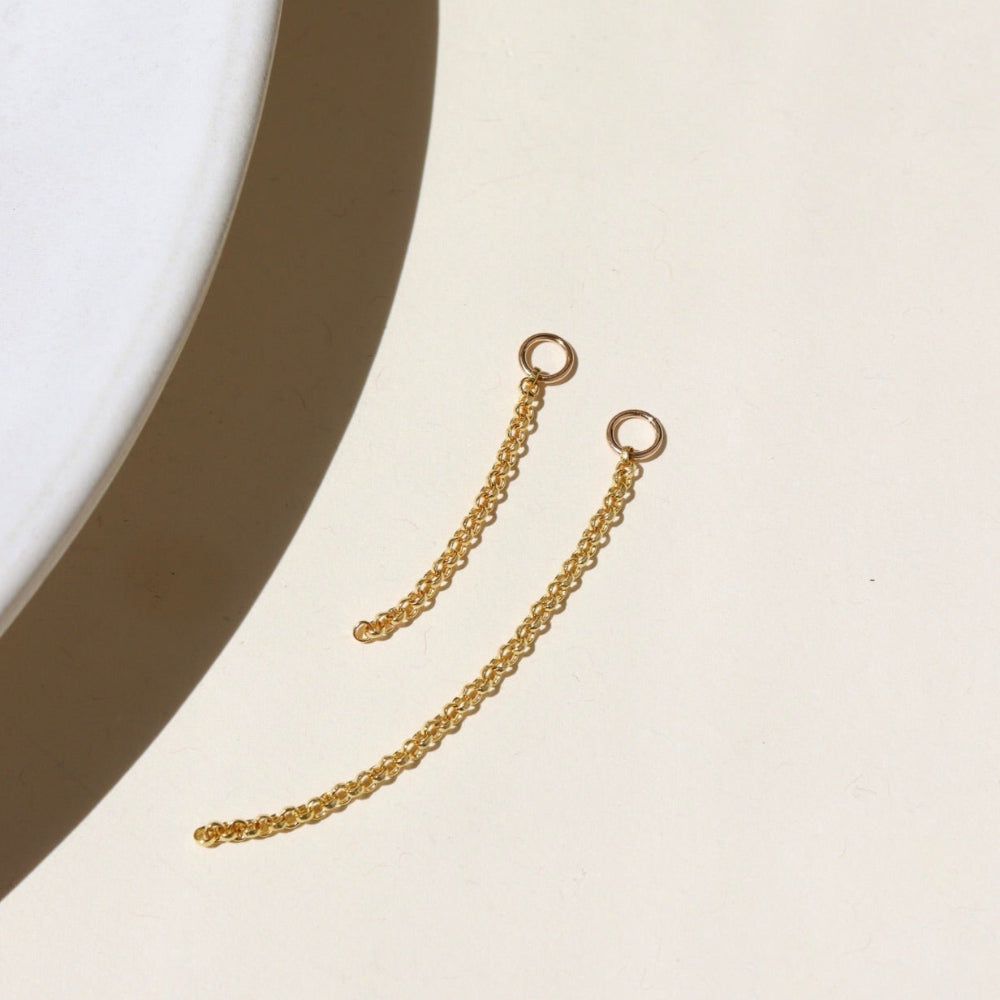 14k gold fill connector earrings, with a small rolo chain dropped from two 4mm jump rings, displayed on a cream backdrop in the sunlight 