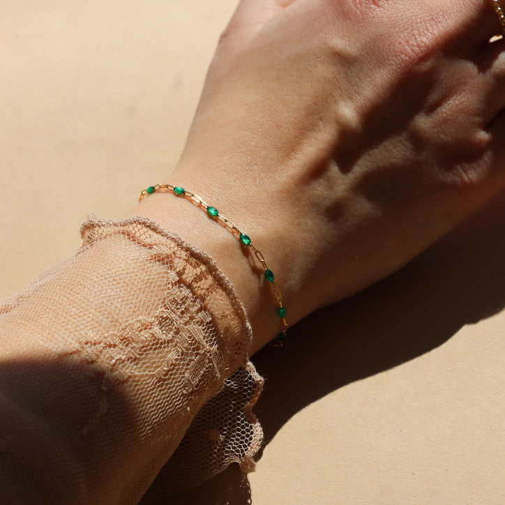 model wearing 14k gold fill gemlink bracelet with emerald