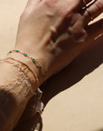 model wearing 14k gold fill gemlink bracelet with emerald