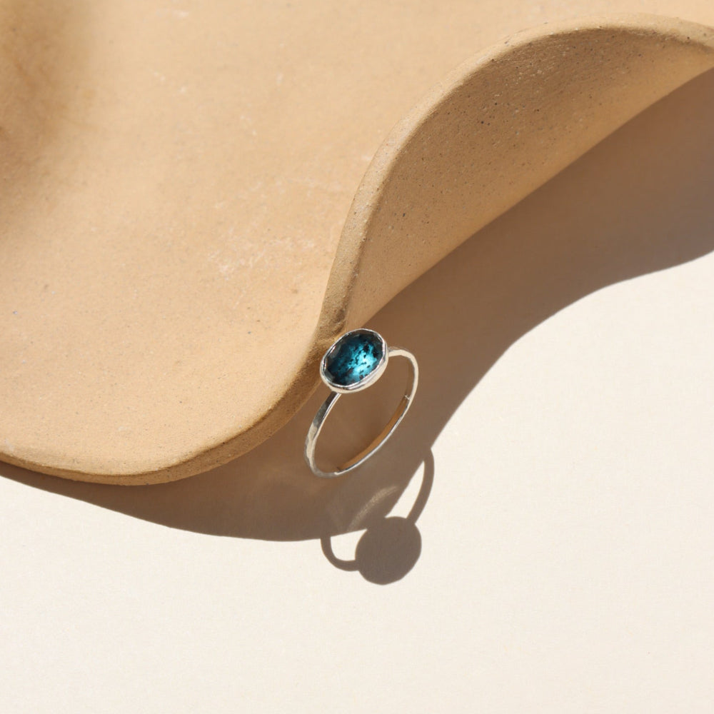 A faceted kyanite gemstone set in a sterling silver bezel. 