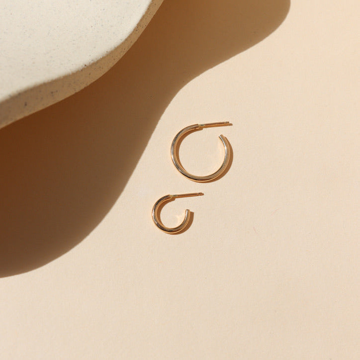14k gold fill hammered hoops on a light background