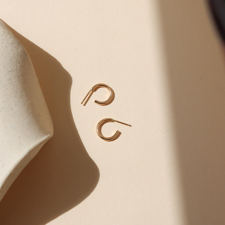 14k gold fill hammered hoops on a light background