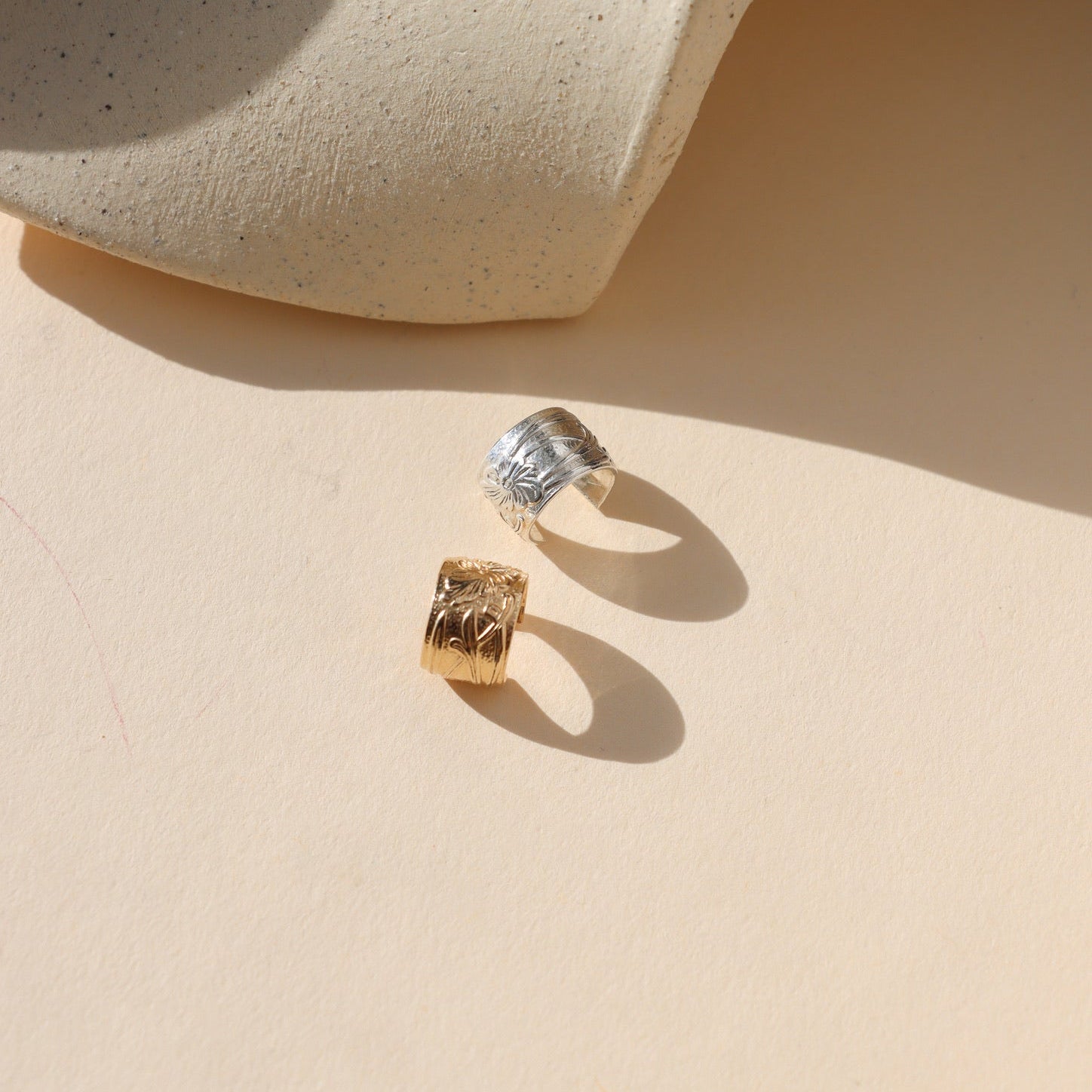 14k gold fill and sterling silver textured ear cuffs in the sunlight