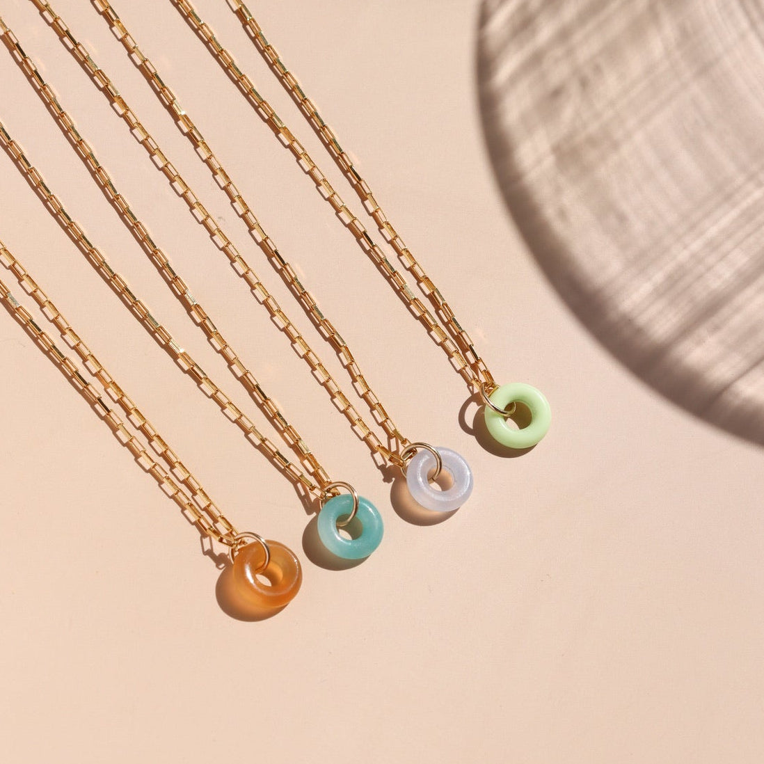 row of 14k gold fill chain necklaces with chrysoprase, agate, amazonite, and chalcedony stone pendants