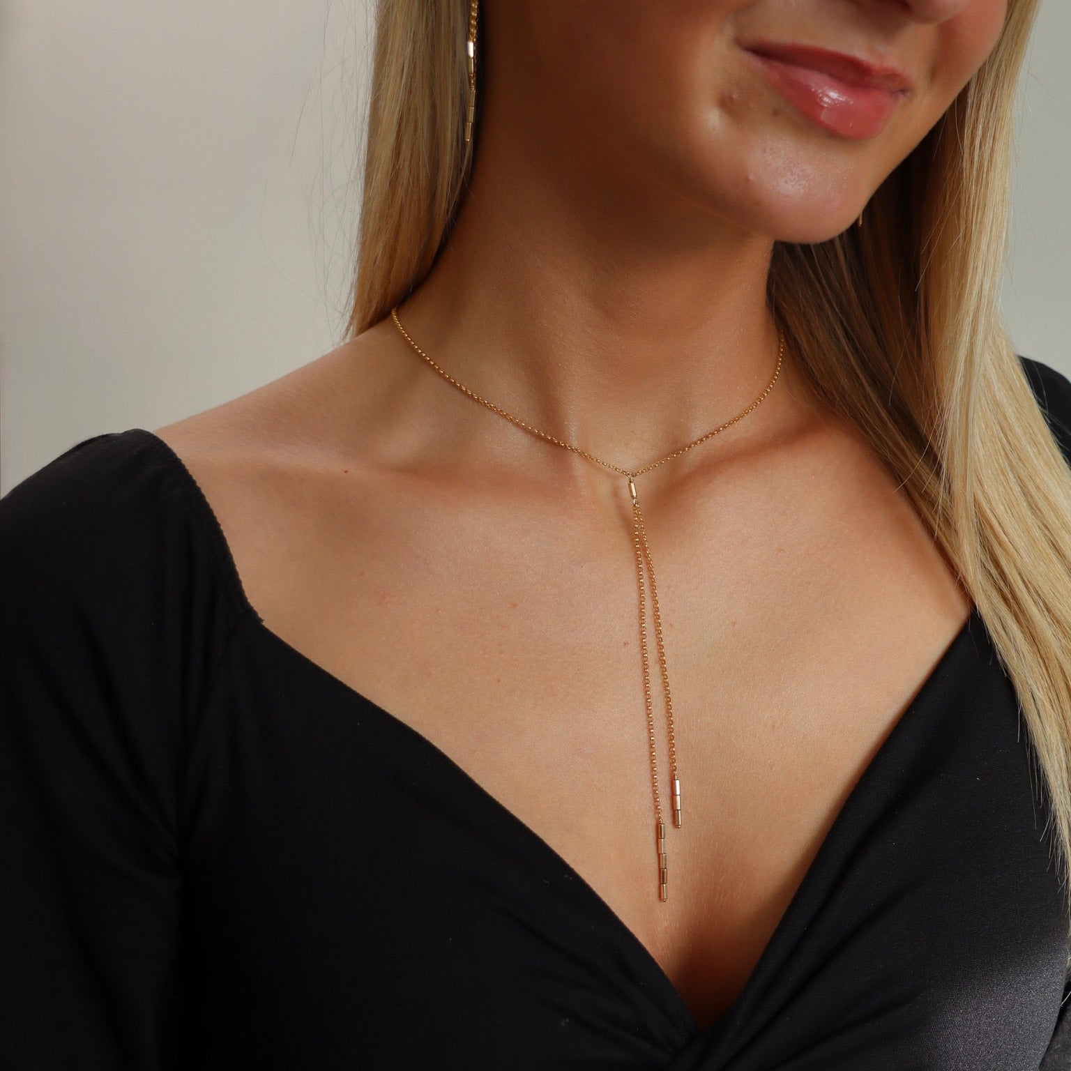 model wearing 14k gold fill chain lariat with bead accents