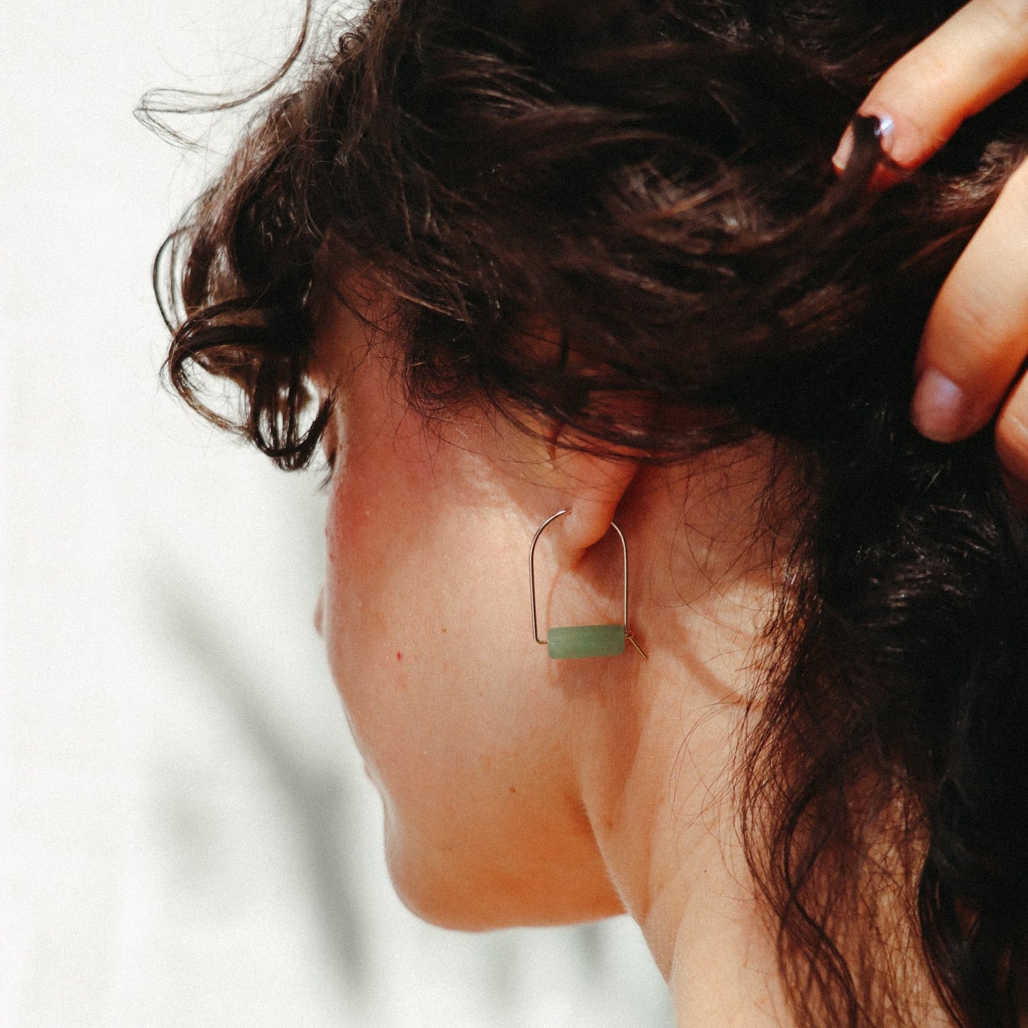 model wearing 14k gold fill arch shaped earrings with aventurine tube beads 