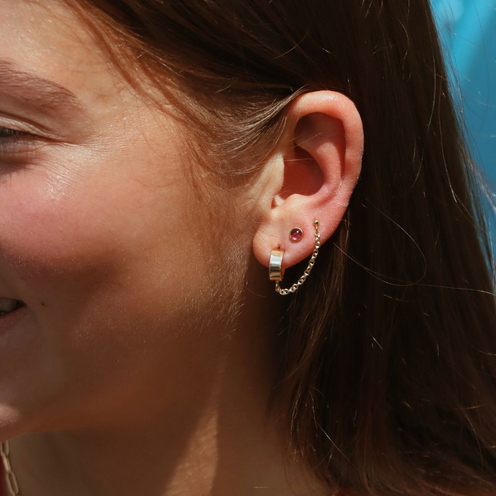 model wearing 14k gold fill chain studs with ruby studs