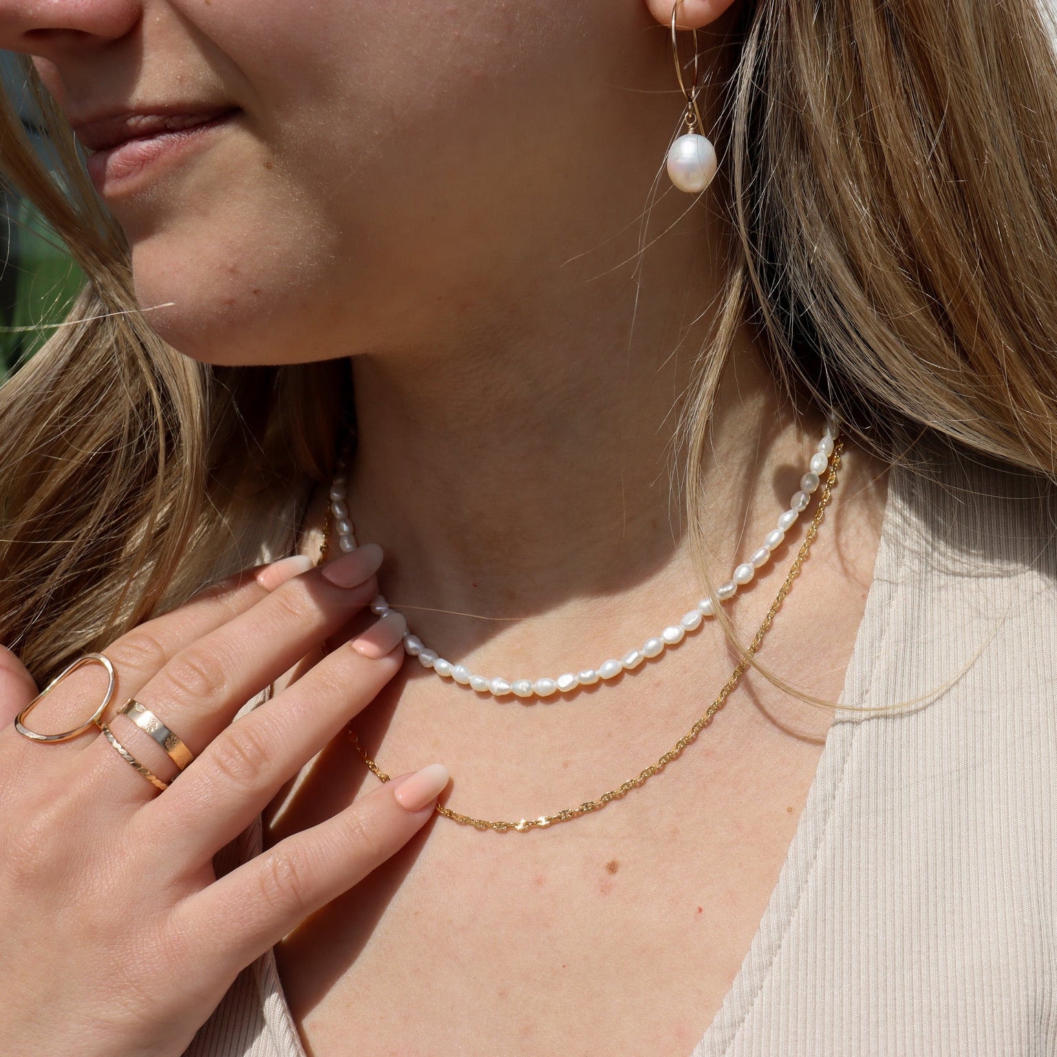 model wearing 14k gold fill chain necklace with hand beaded pearl necklace