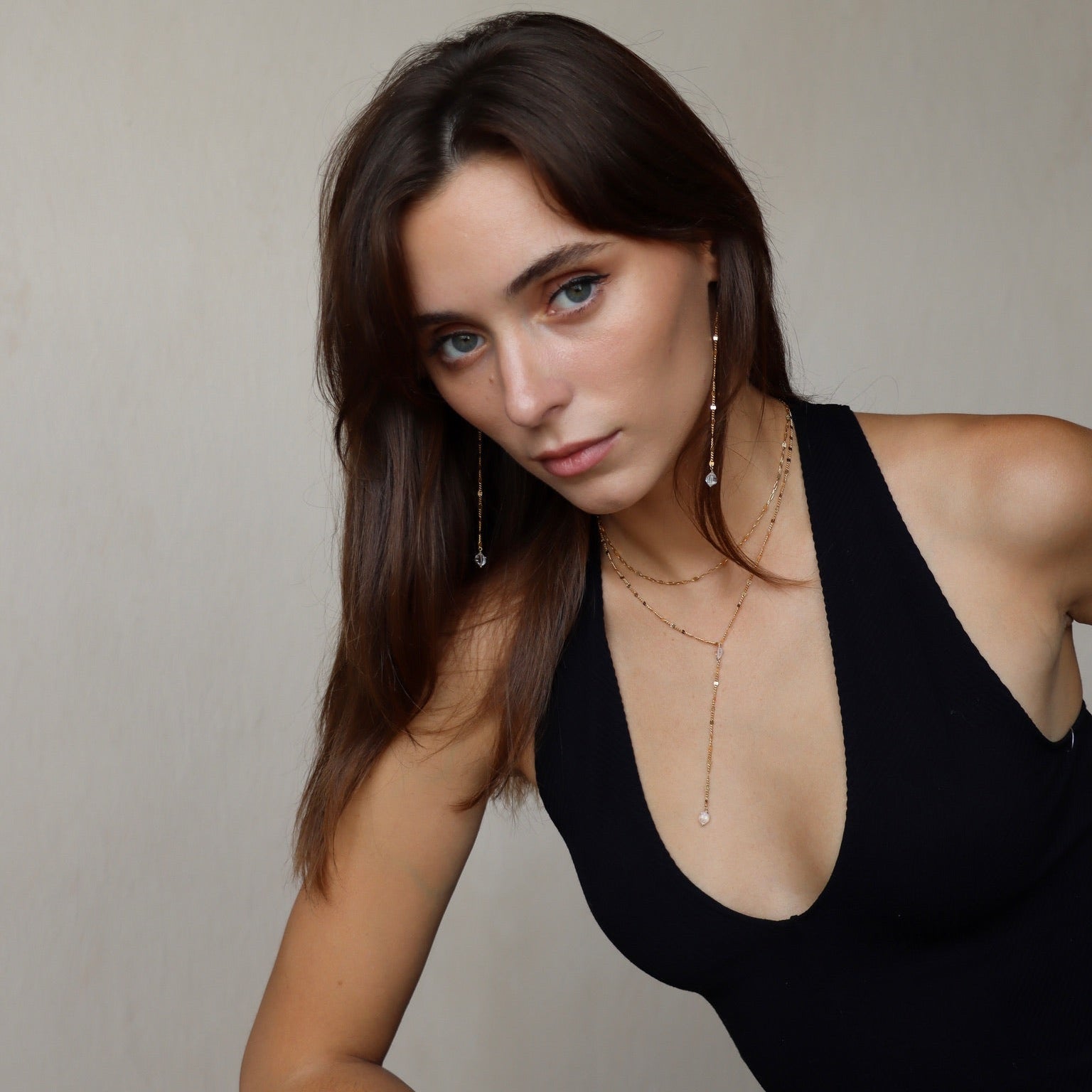 Model wearing gold-filled Herkimer Diamond drop earrings made with Sunburst chain. Minimal and dramatic, handmade for everyday glow.