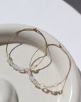 14k gold fill or sterling silver hoops, handmade and lightly hammered for shine, then adorned with six genuine australian opals that are delicately wire-wrapped. Handmade by Token Jewelry in Eau Claire, WI