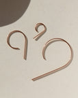 14k rose gold fill "nine" earrings all three sizes laying side by side
