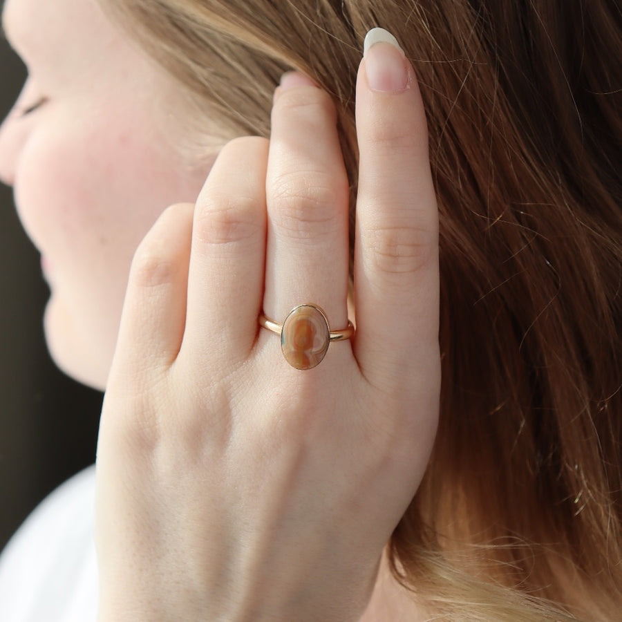 a 14k gold fill hand-set ocean jasper ring photographed on a model's hand