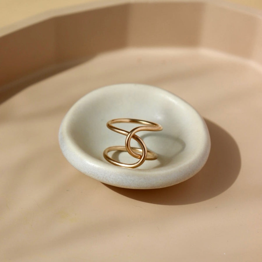 14k gold fill ring on a tan colored plate. Handmade in Eau Claire Wisconsin.