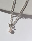 925 sterling silver chain with a toggle clasp and large pearl, photographed on a sunlit tabletop