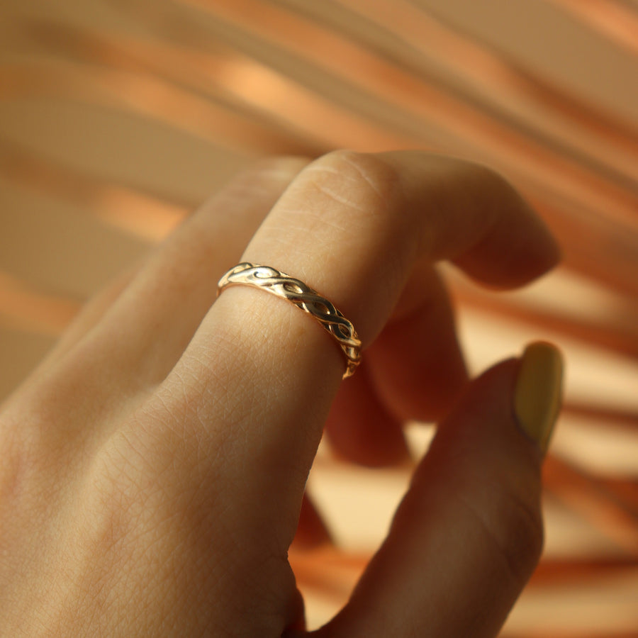 Model is wearing 14k gold fill Helix ring.This ring feature a small twist like band.