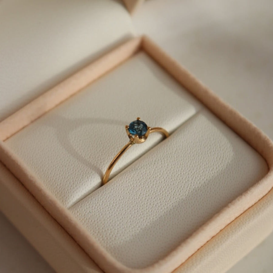 A timeless soft London blue topaz sits on a 14k gold solitaire band, December birthstone, soft blue hue, gift, handmade in eau claire, wisconsin, handmade jewelry, heirloom collection, everyday solid gold, solitaire ring, blue gemstone ring