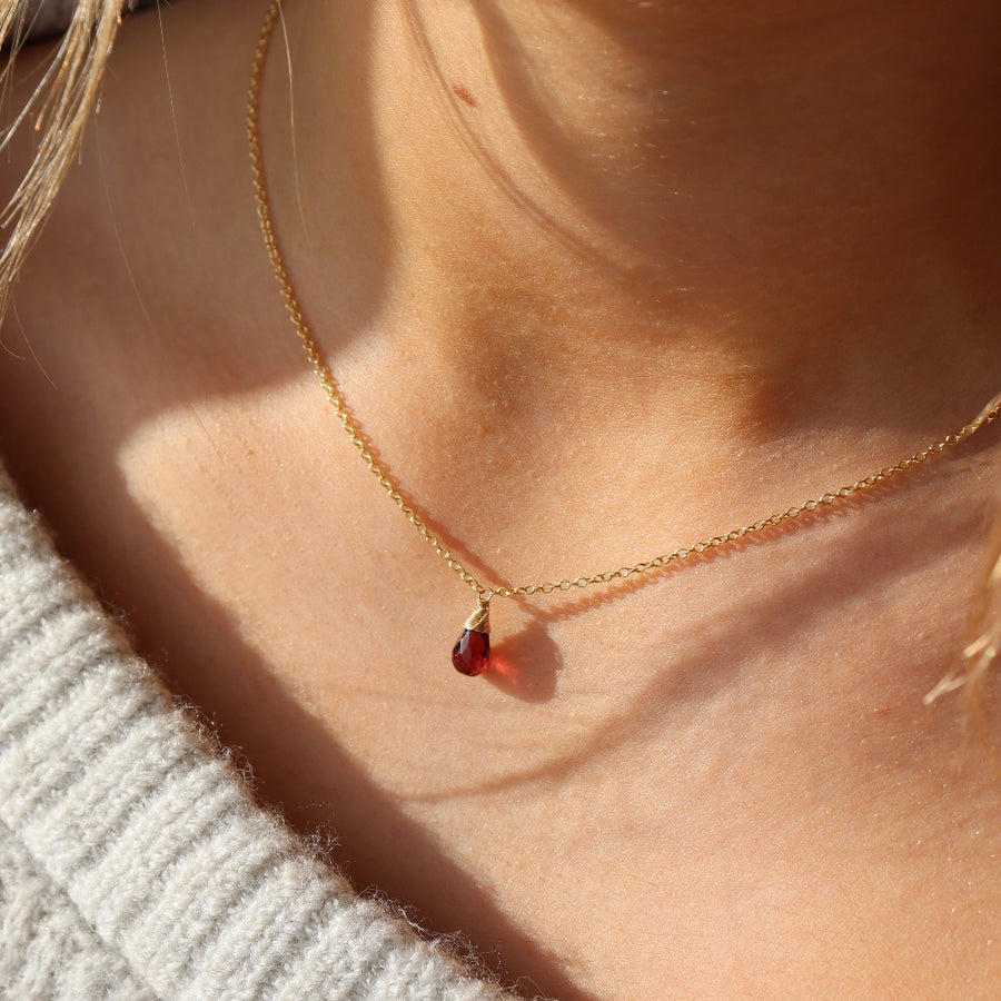 dainty red garnet necklace pictured on a model