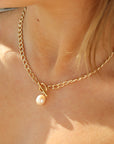 14k gold fill chain with a toggle clasp and large pearl, pictured on a model