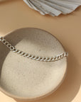 925 Sterling Silver Double link bracelet laid on top of a white clay plate. Jewelry is handmade in Eau Claire Wisconsin. Hypoallergenic jewelry made to live in.