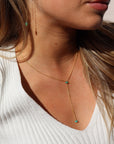 Model wearing 14k gold fill Green opal lariat. This necklace features our simple chain connected by the Green opal gemstone dangling on the lariat is another green opal lariat.