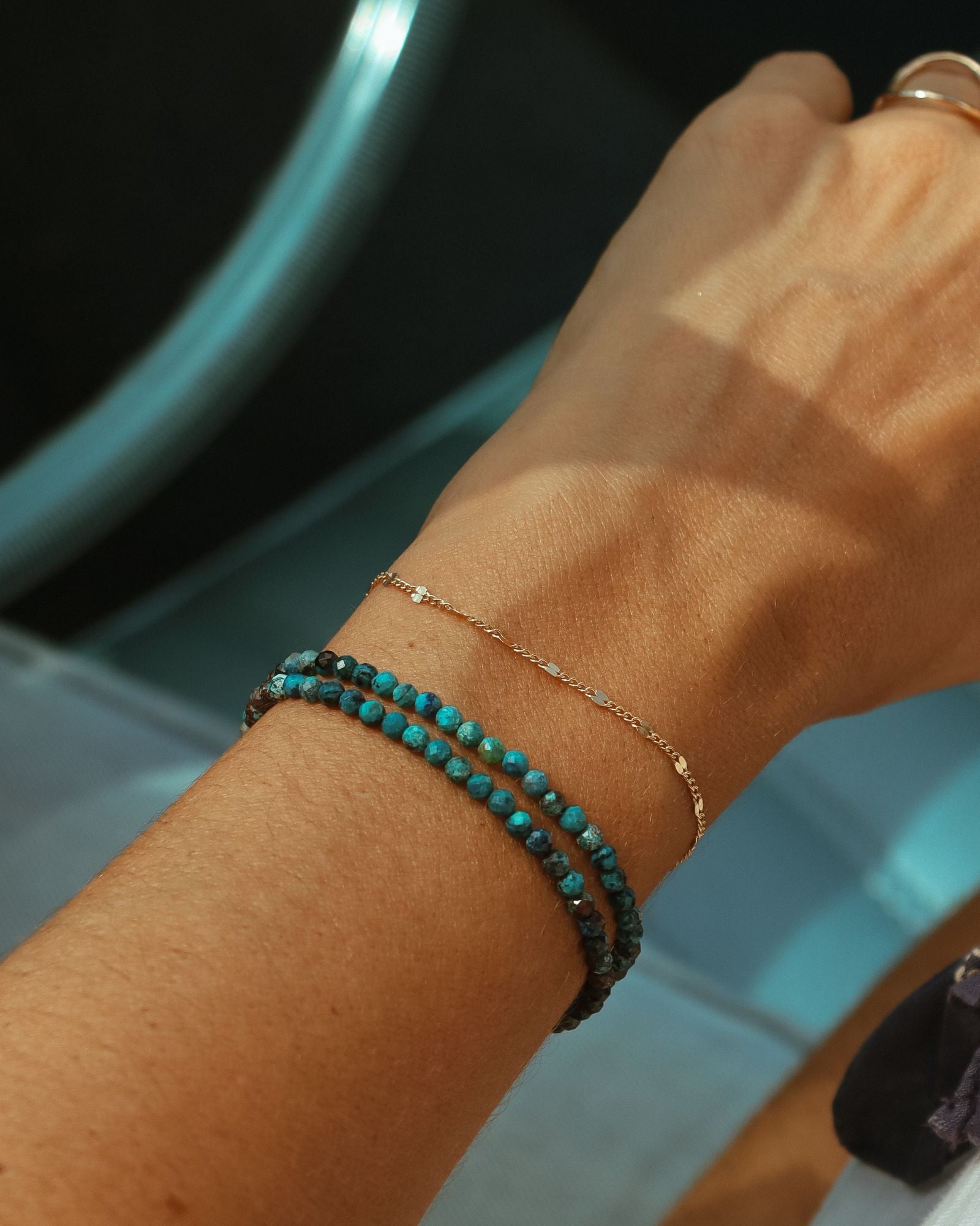 model wearing chrysocolla beaded bracelet with chain bracelet