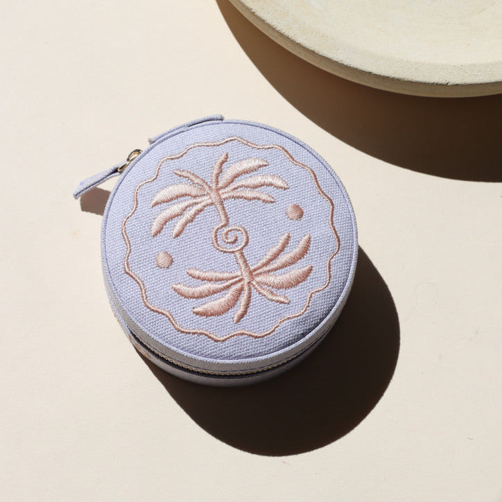 lavender circle travel jewelry case on a light background