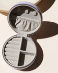 lavender circle travel jewelry case opened on a light background