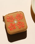 square travel jewelry case on a light background
