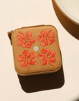square travel jewelry case on a light background