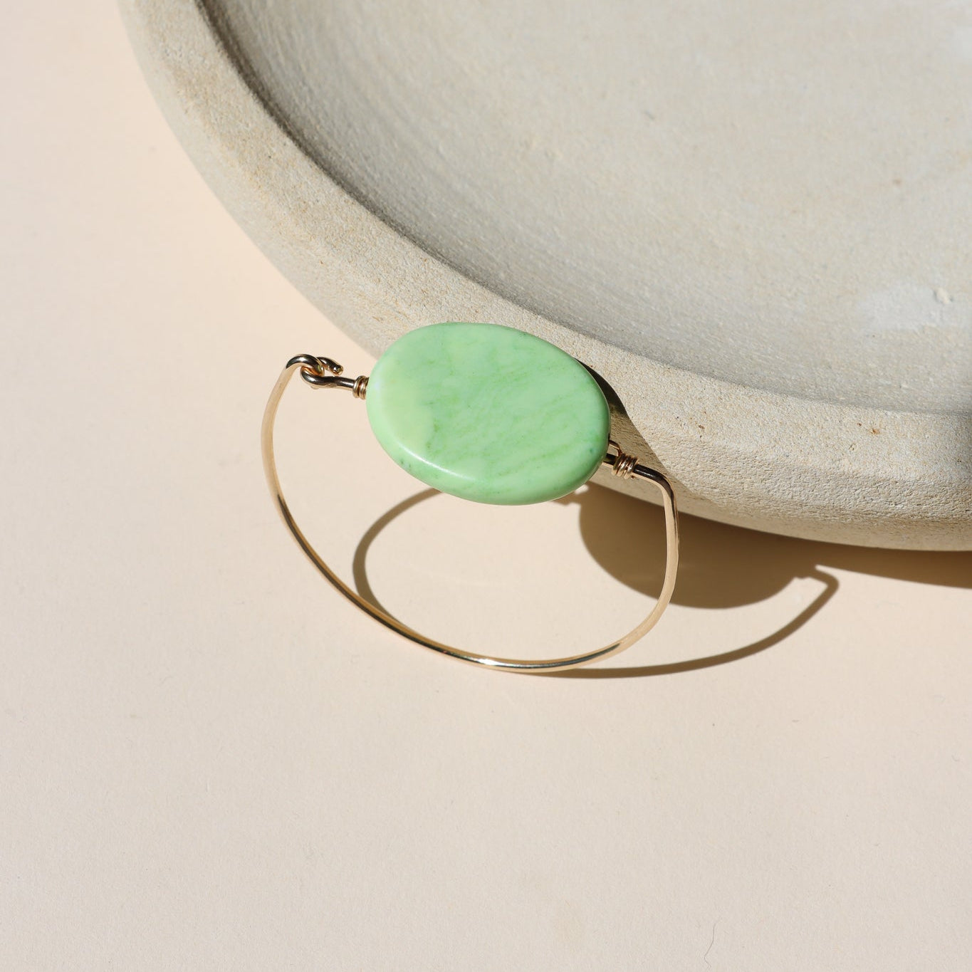 14k gold fill wire bracelet with oval chrysoprase stone in the sunlight