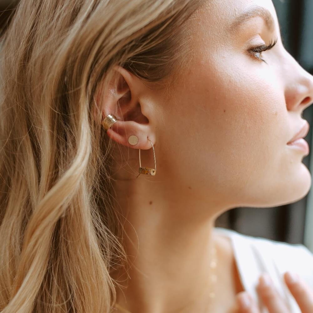 model wearing 14k gold fill hand shaped arch earrings with leopard jasper stones 