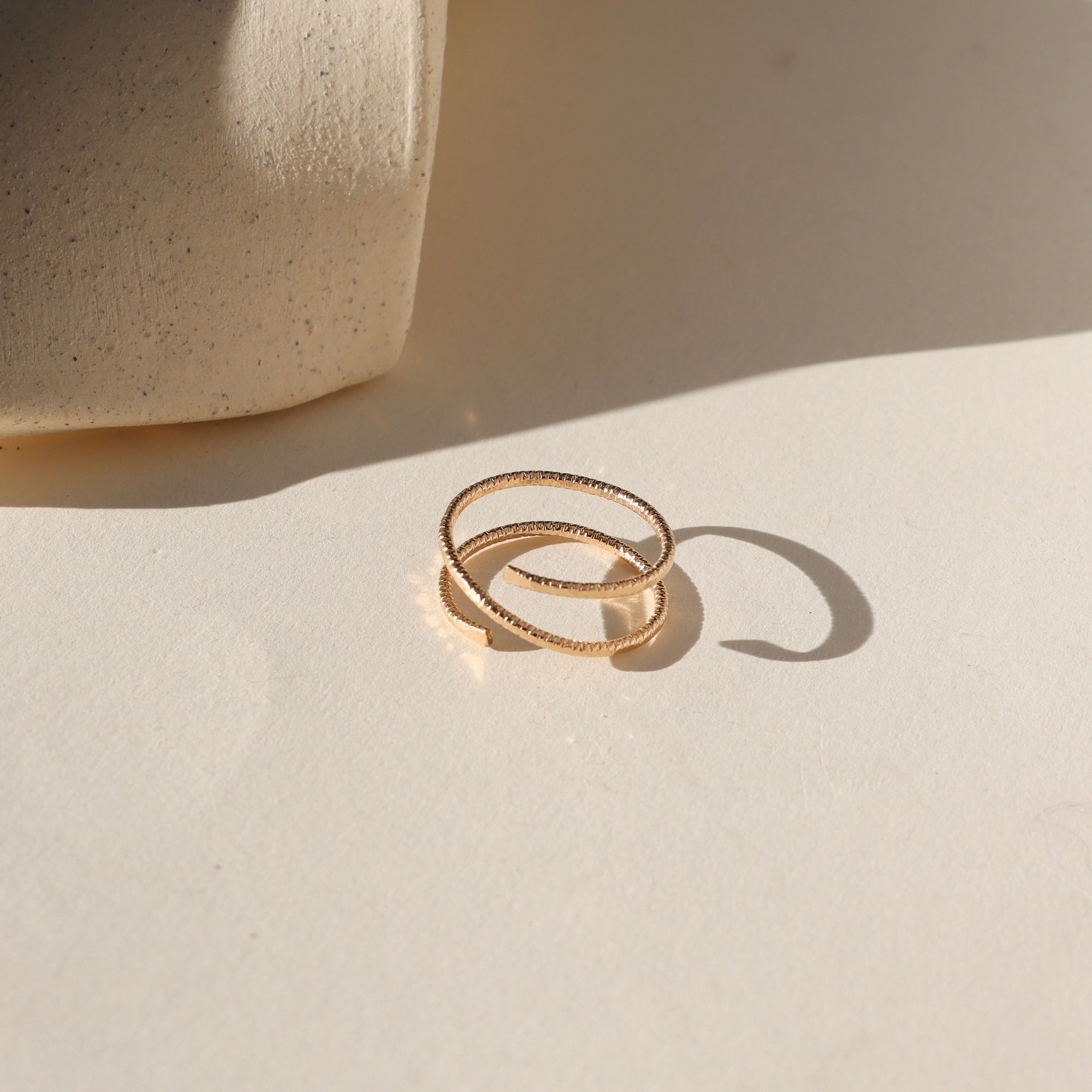 Lumen Ring handcrafted in 14k gold fill with a light-catching hammered texture.