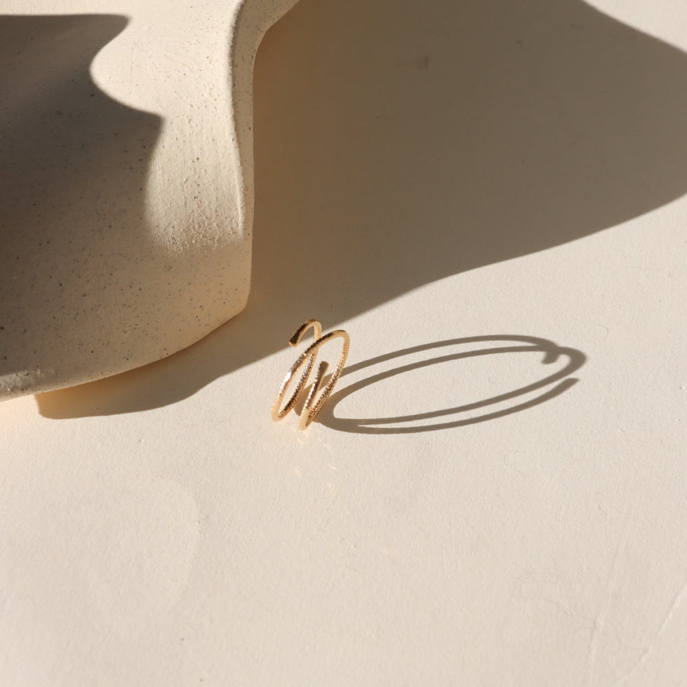 Lumen Ring handcrafted in 14k gold fill with a light-catching hammered texture.