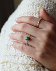 sterling silver ring with a green malachite stone, photographed on a model | handmade by Token Jewelry in Eau Claire, Wisconsin