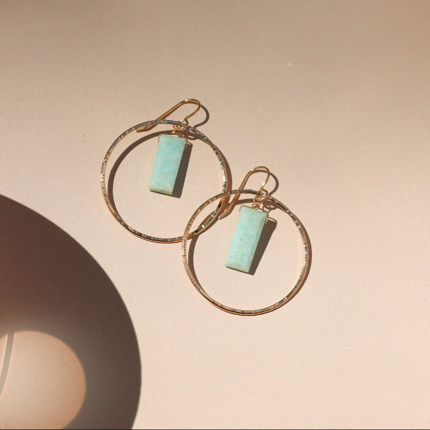 14k gold fill hammered round components with rectangle amazonite stones on a french ear wire on a light dish
