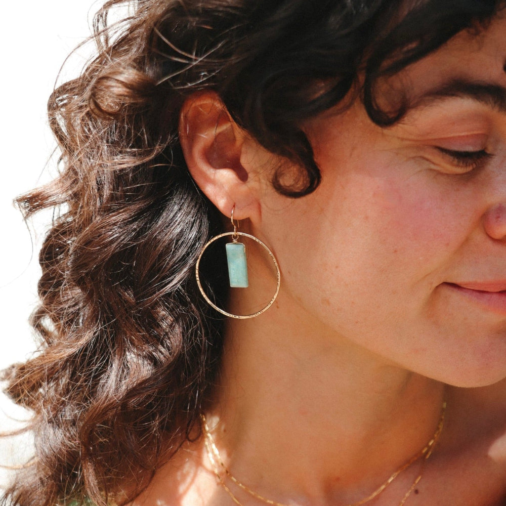 model wearing 14k gold fill hammered round components with rectangle amazonite stones on a french ear wire