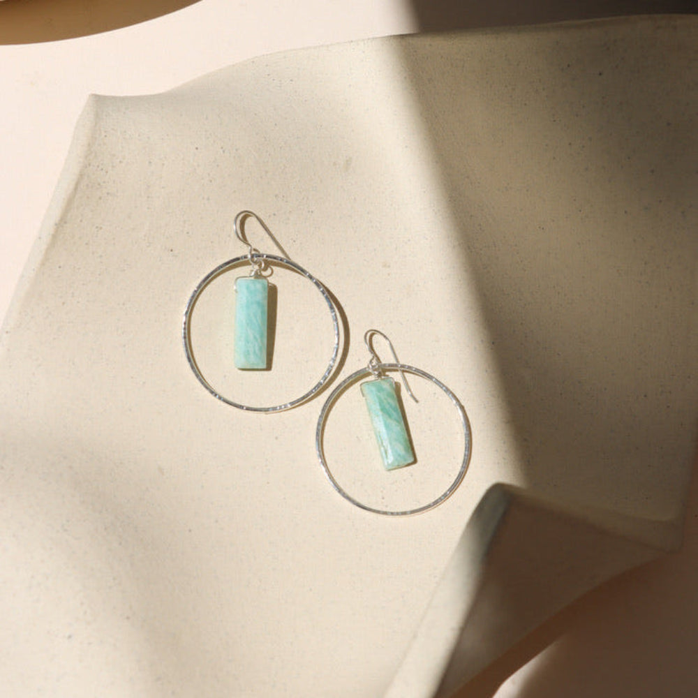 sterling silver hammered round components with rectangle amazonite stones on a french ear wire on a light dish
