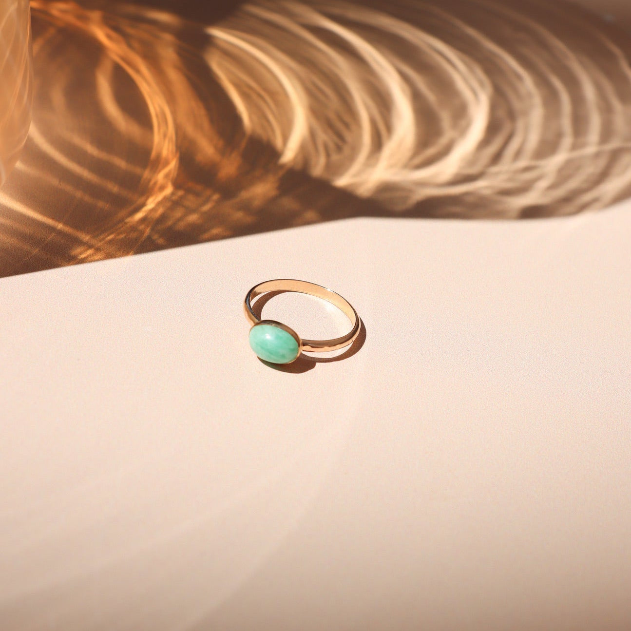14k gold fill ring with oval amazonite stone on a light surface