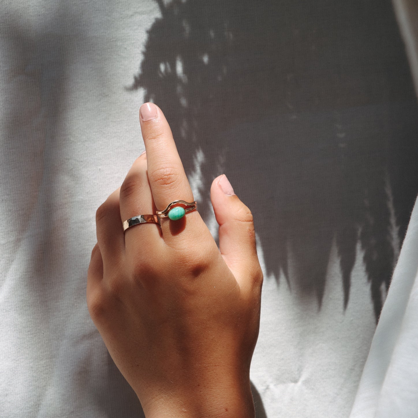 model wearing 14k gold fill rings and 14k gold fill gemstone ring with oval amazonite stone