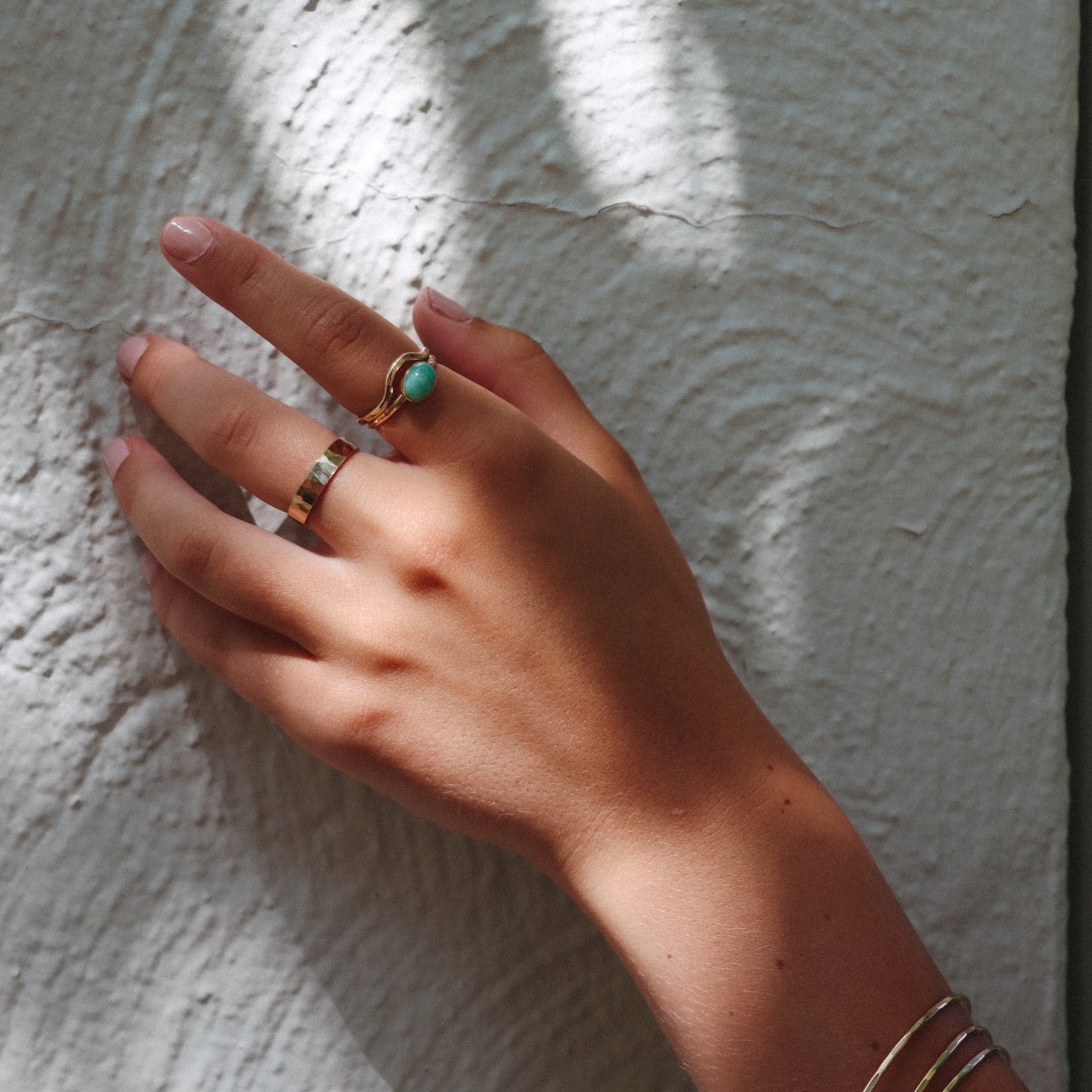 model wearing 14k gold fill rings and 14k gold fill gemstone ring with oval amazonite stone