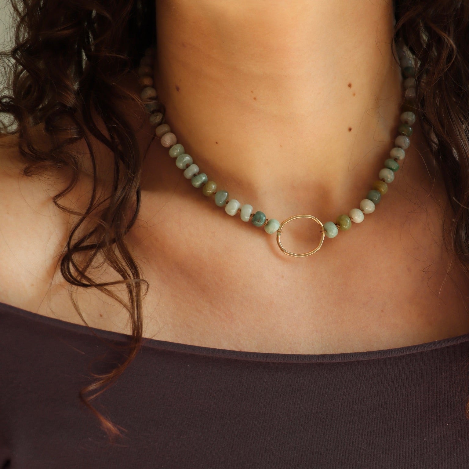model wearing handmade circle pendant with jade beads 
