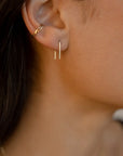 model wearing 14k gold fill staple shaped earrings with 14k gold fill ear cuff
