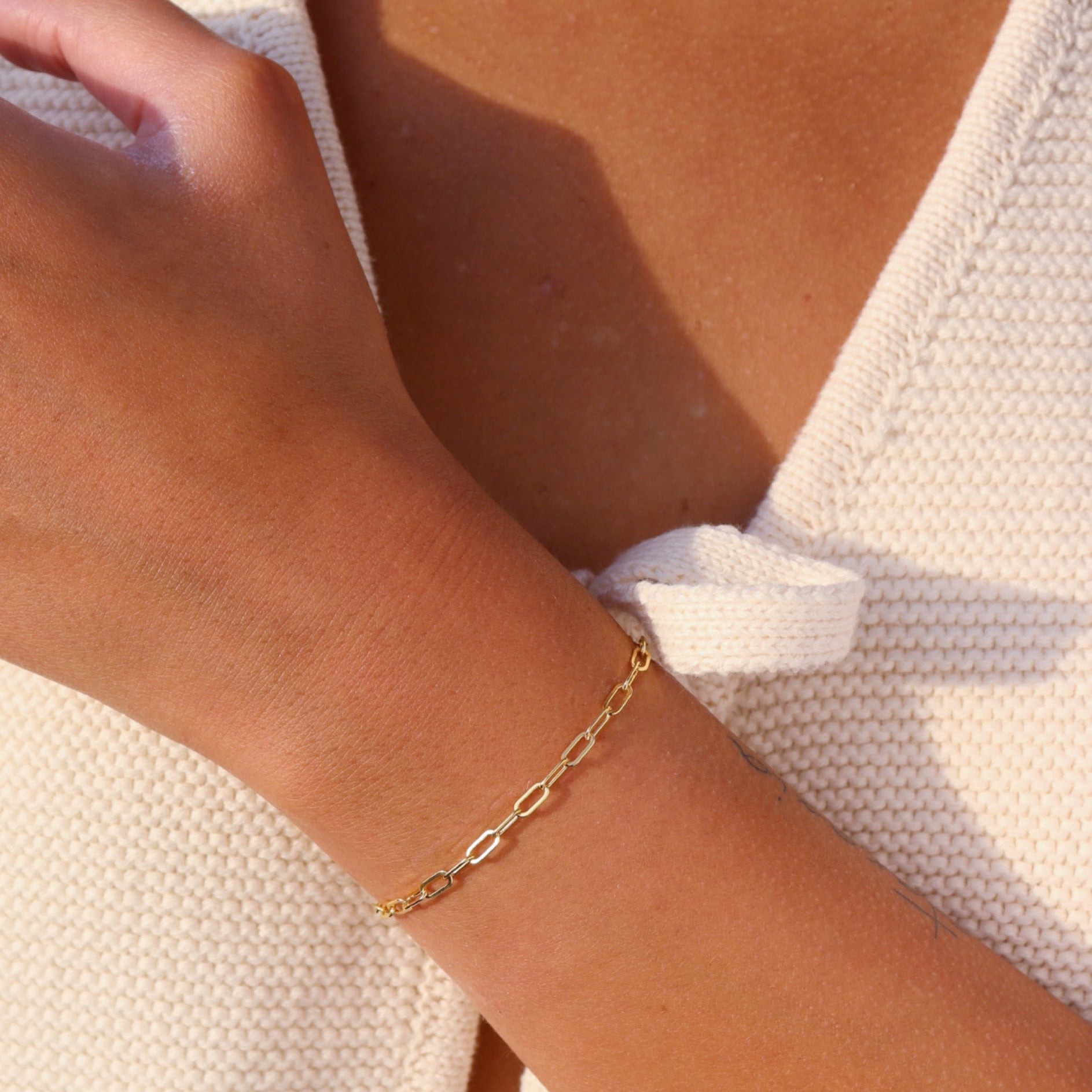 model wearing 14k gold fill paperclip chain bracelet 