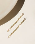 14k gold fill long paperclip chain dropped from a 4mm jump ring, displayed on a cream backdrop in the sunlight 
