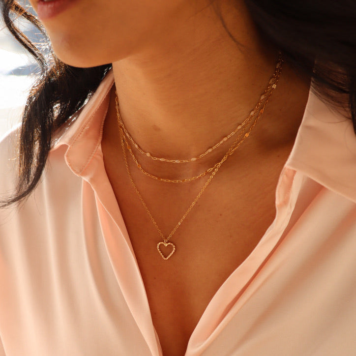 model wearing various 14k gold fill necklaces