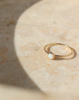 14k gold fill bezel ring setting with smooth 4mm opal stone on a light background