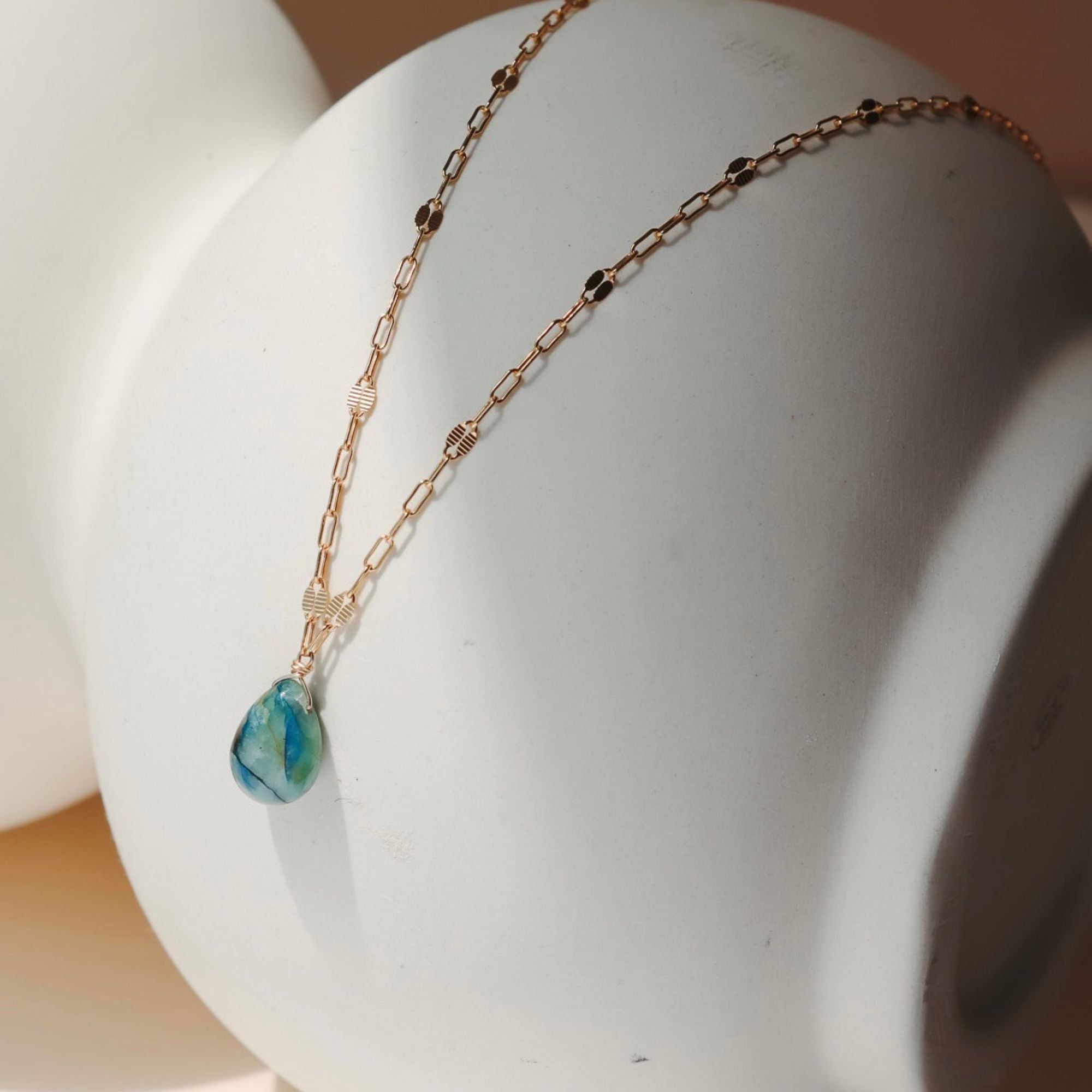 14k gold fill chain necklace with teardrop stone pendant in the sunlight
