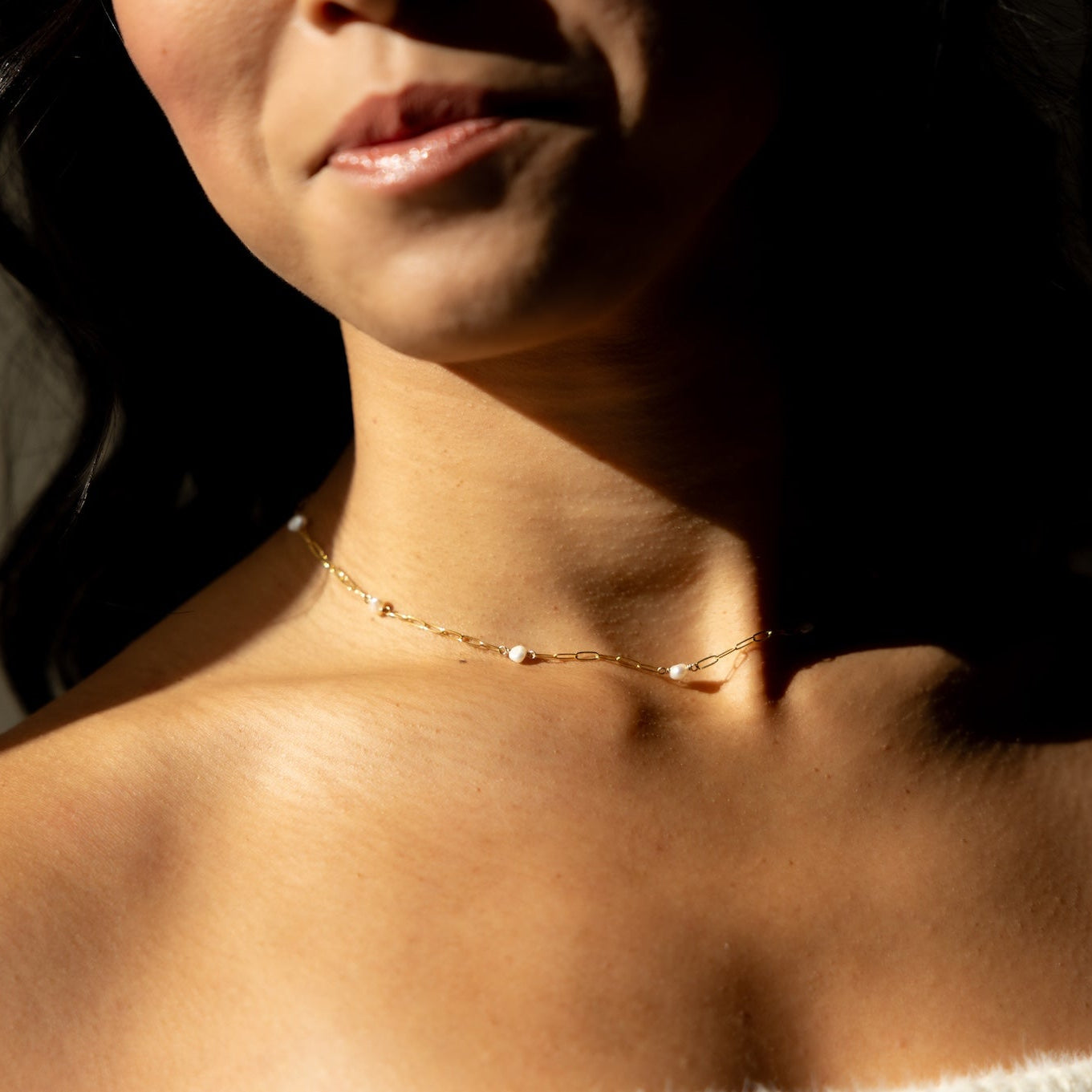 Gold Cosette chain necklace accented with a single lustrous freshwater pearl.
